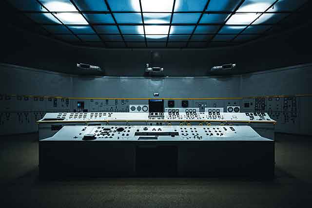Photo of a dimly lit room with a computer interface terminal.