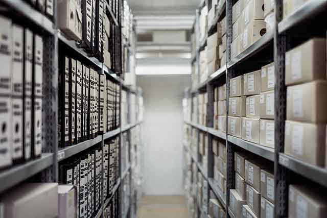 Photo of a warehouse with stacked shelves.